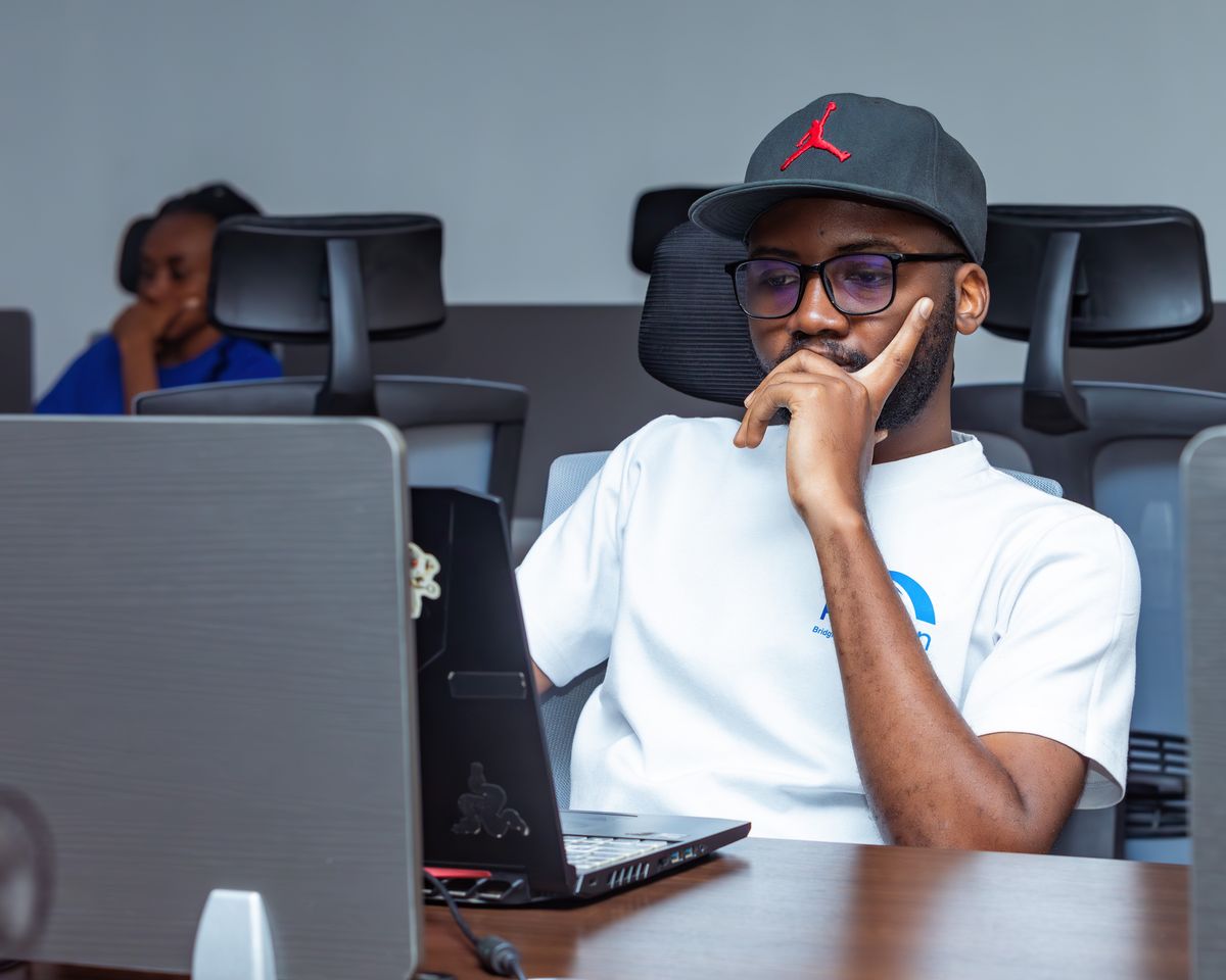 A young professional focused on work at a laptop