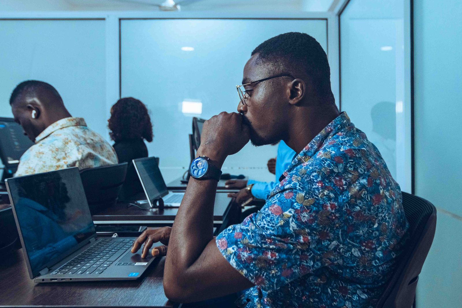 People learning at laptops during a technology workshop