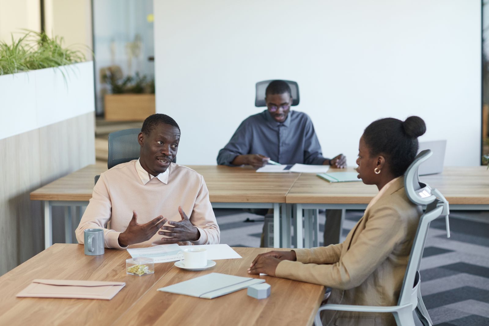 Colleagues reviewing plans together around an office table